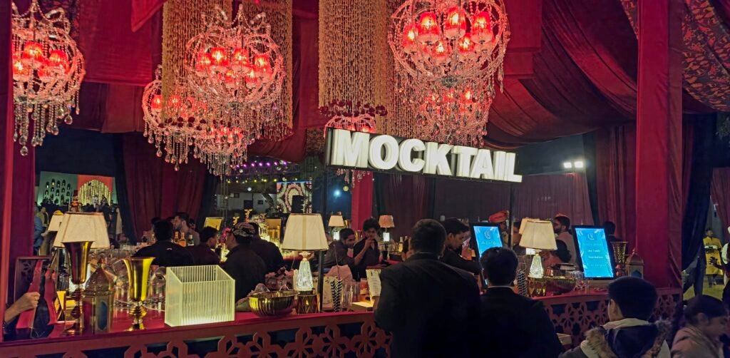 A luxury mobile bar setup by Pour & Co. at a Jim Corbett destination wedding, featuring a professional mixologist crafting premium bespoke cocktails against a lush, jungle resort backdrop.