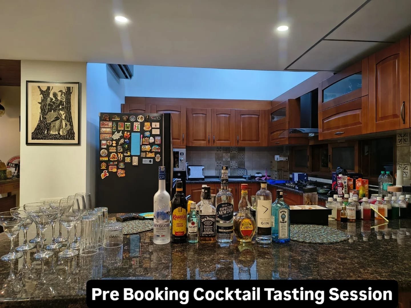 A luxury mobile bar setup for Pour & Co. featuring premium liquor bottles, crystal martini and wine glasses, and fresh cocktail garnishes neatly arranged on a granite countertop.