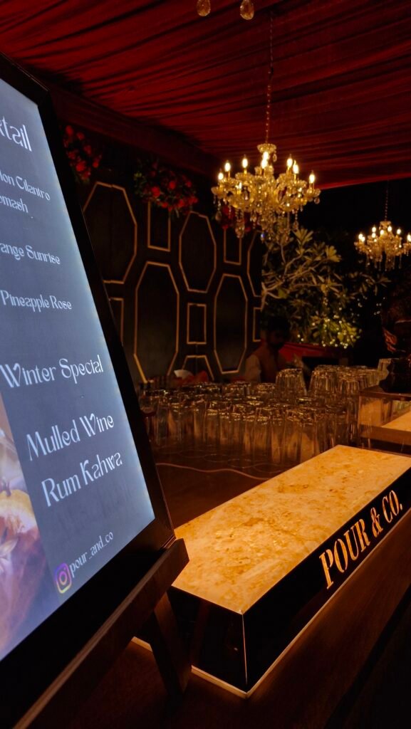 A close-up of custom wedding drinks and zero-proof craft mocktails featuring fresh botanical garnishes at a luxury Udaipur event bar.